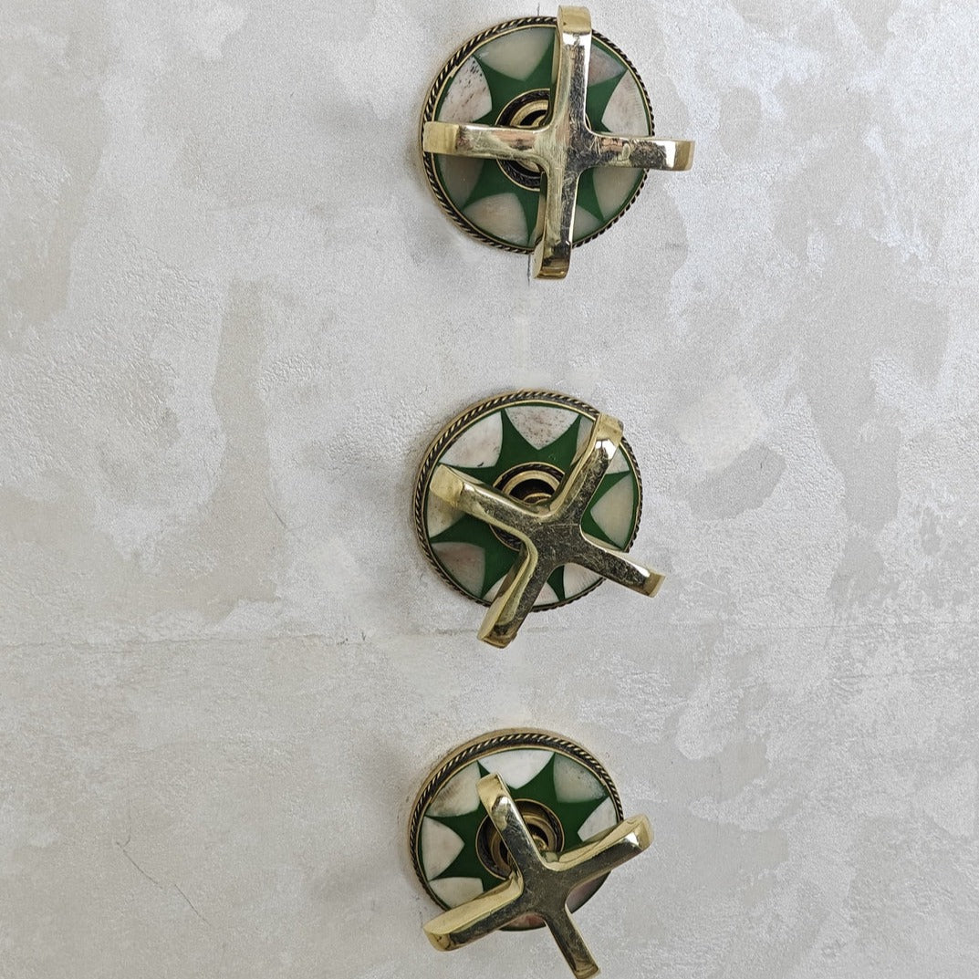 green decorated shower system handles