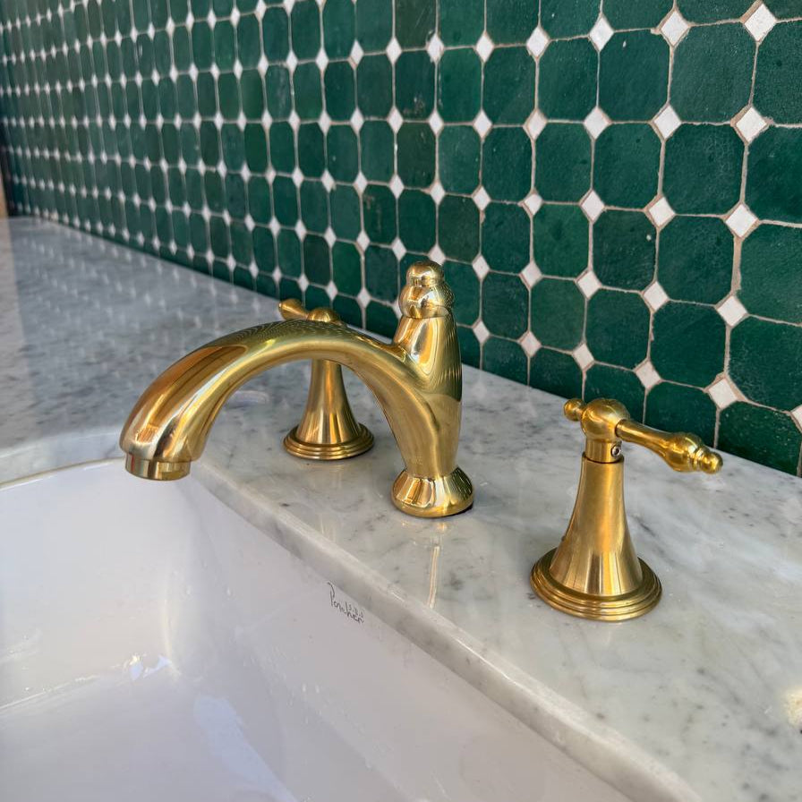 unlacquered brass bathroom faucet with lever handles