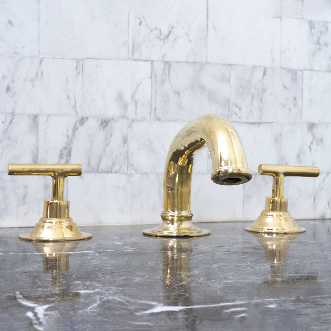 unlacquered brass bathroom faucet with lever handles