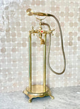 unlacquered brass freestanding tub filler with handheld and handshower
