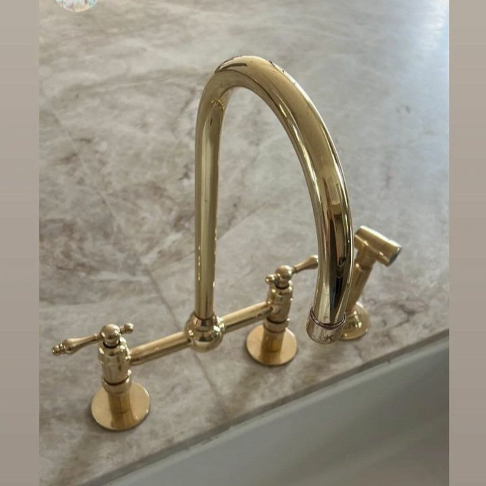 unlacquered brass kitchen faucet with sprayer