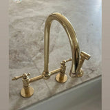 unlacquered brass kitchen faucet with sprayer