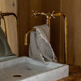 unlacquered brass kitchen faucet with two long legs