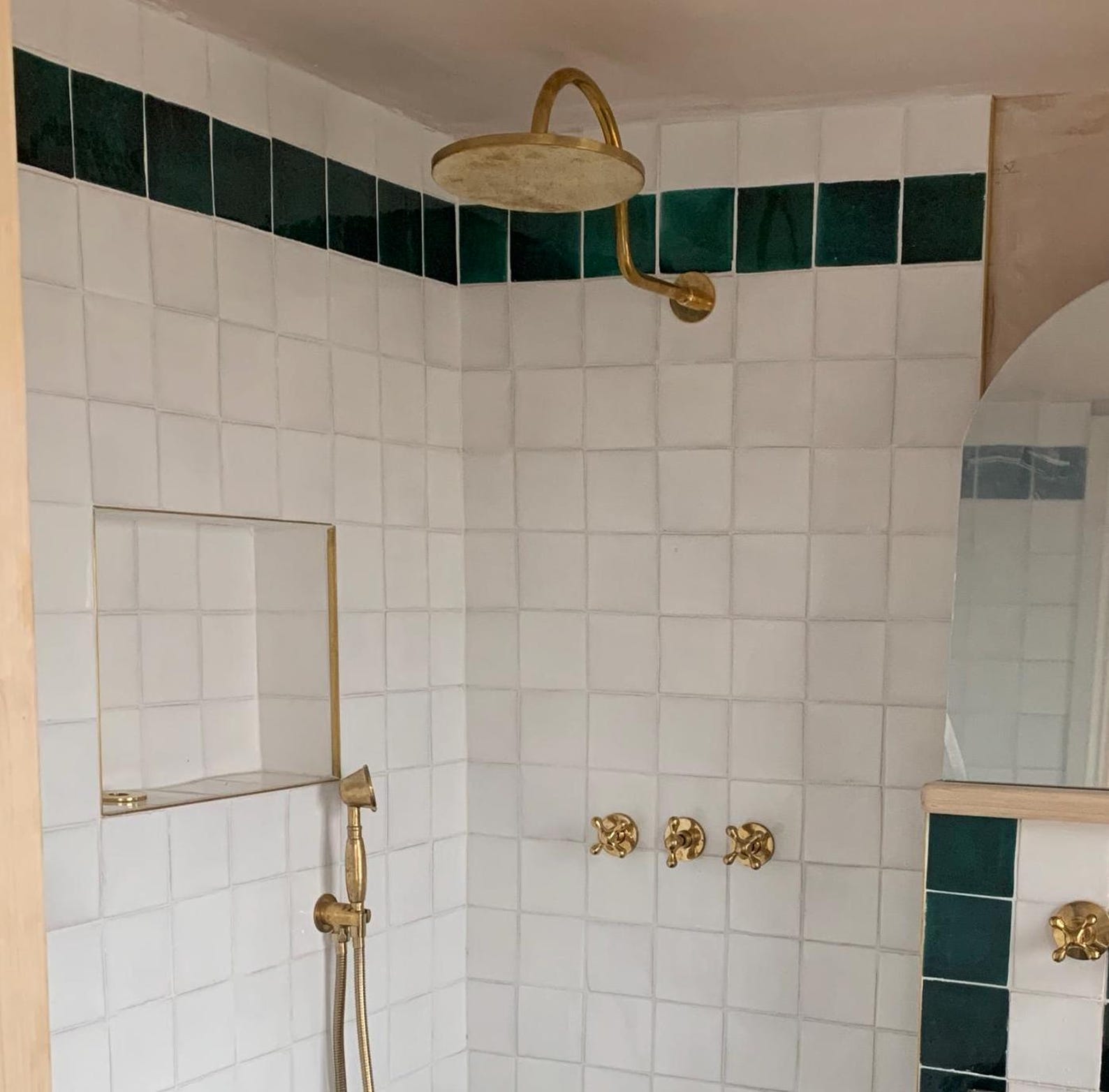 unlacquered brass shower system with handheld