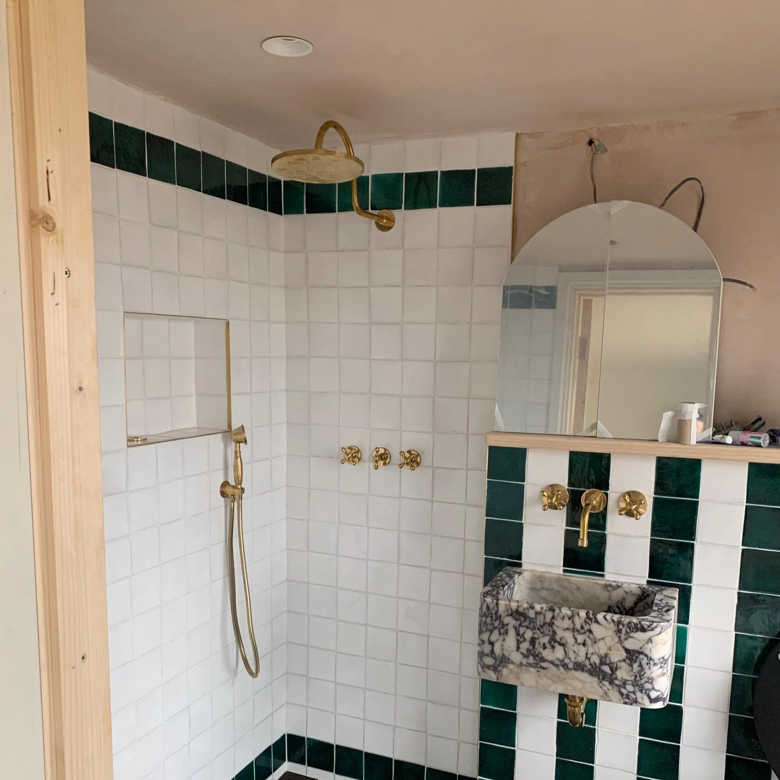 unlacquered brass shower system with handheld