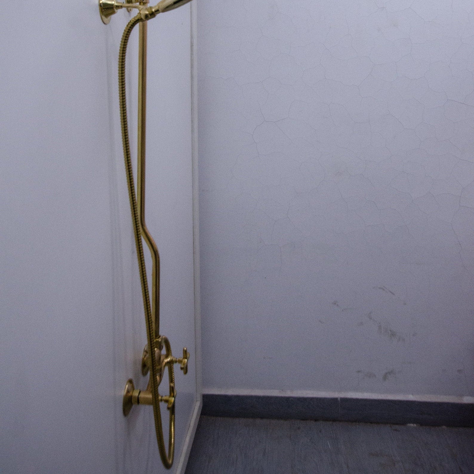 unlacquered brass shower system with handheld