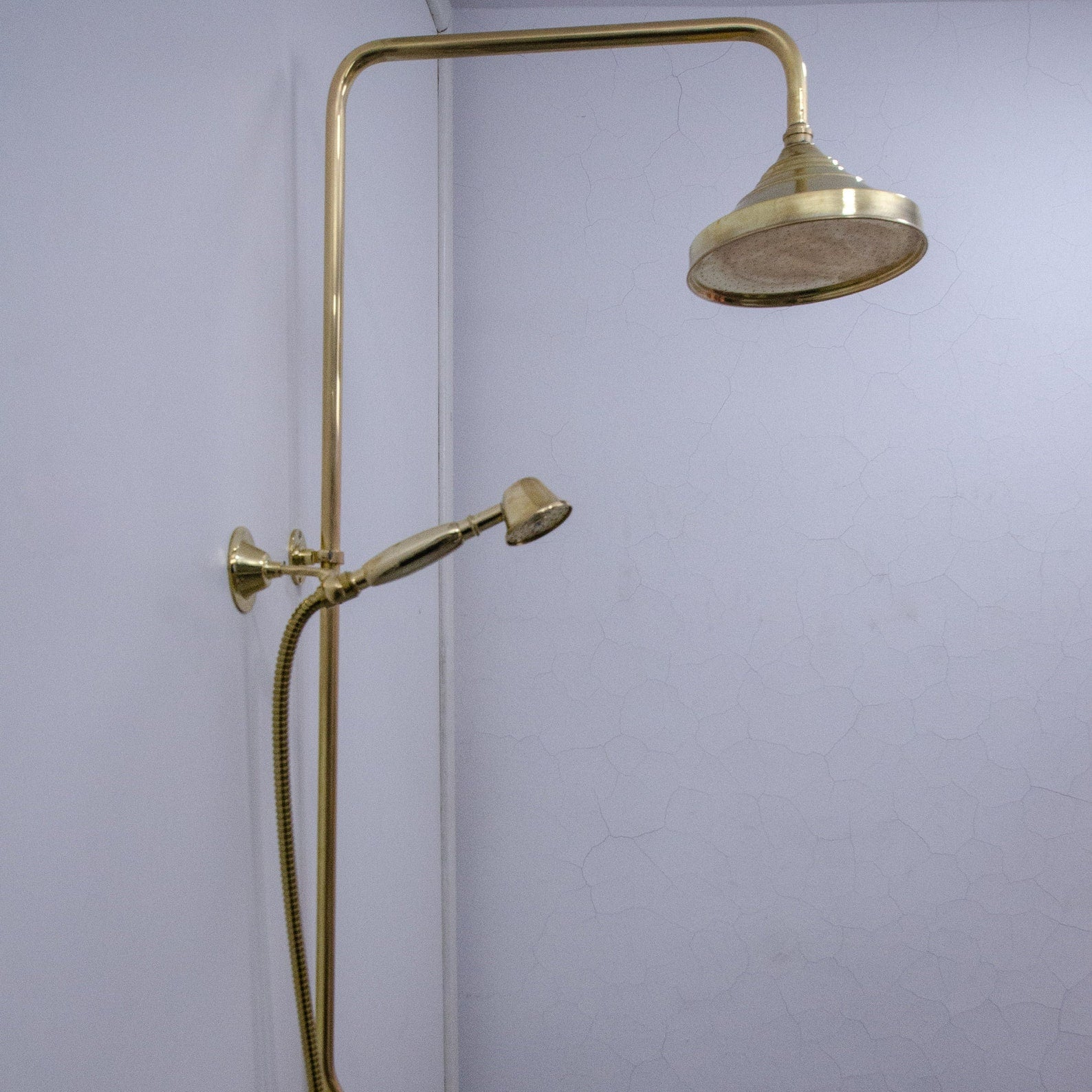 unlacquered brass shower system with handheld