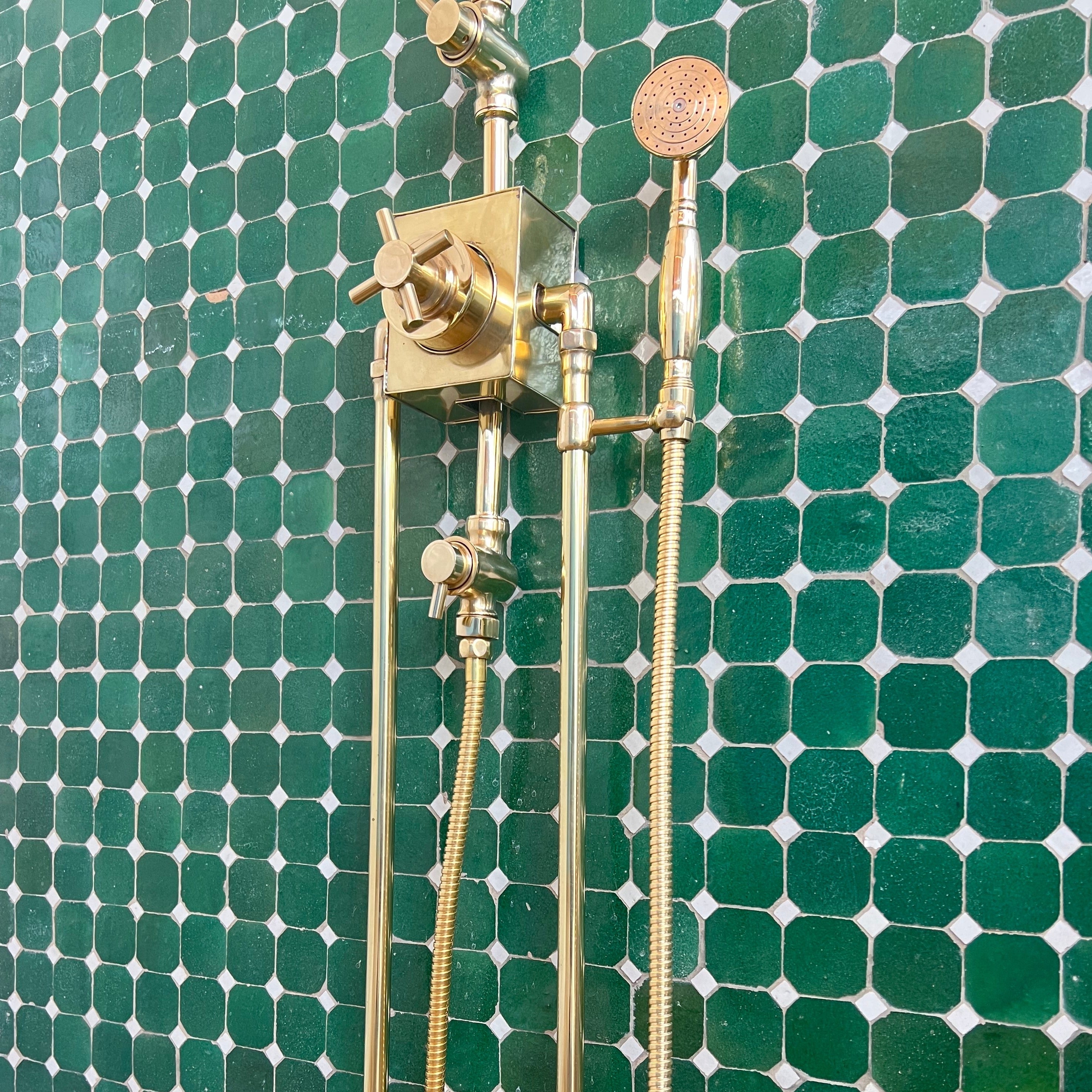 unlacquered brass thermostatic shower system with long legs and shower hand