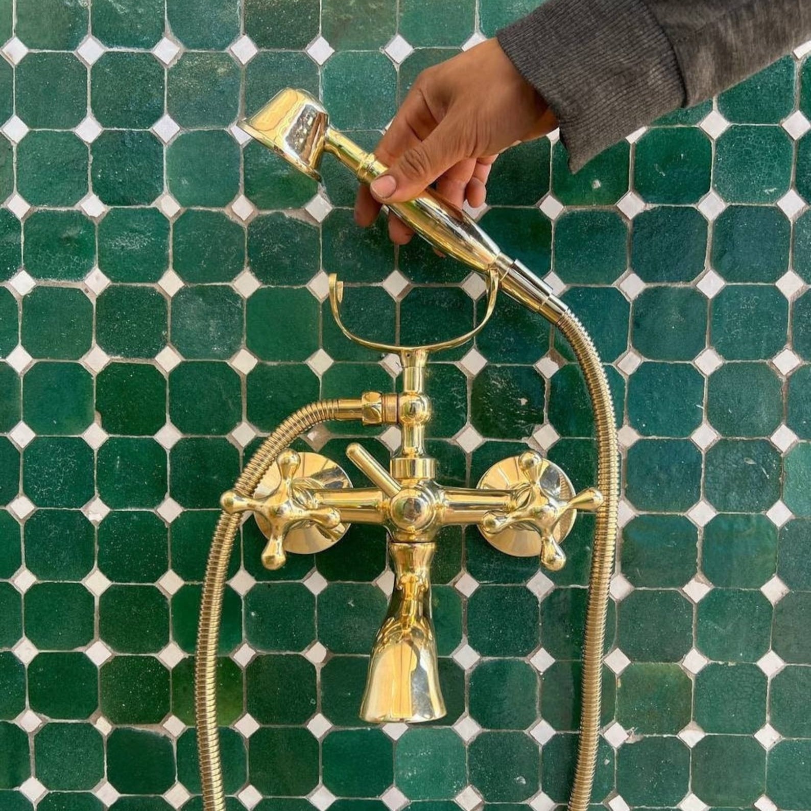 unlacquered brass wall tub faucet with shower hand