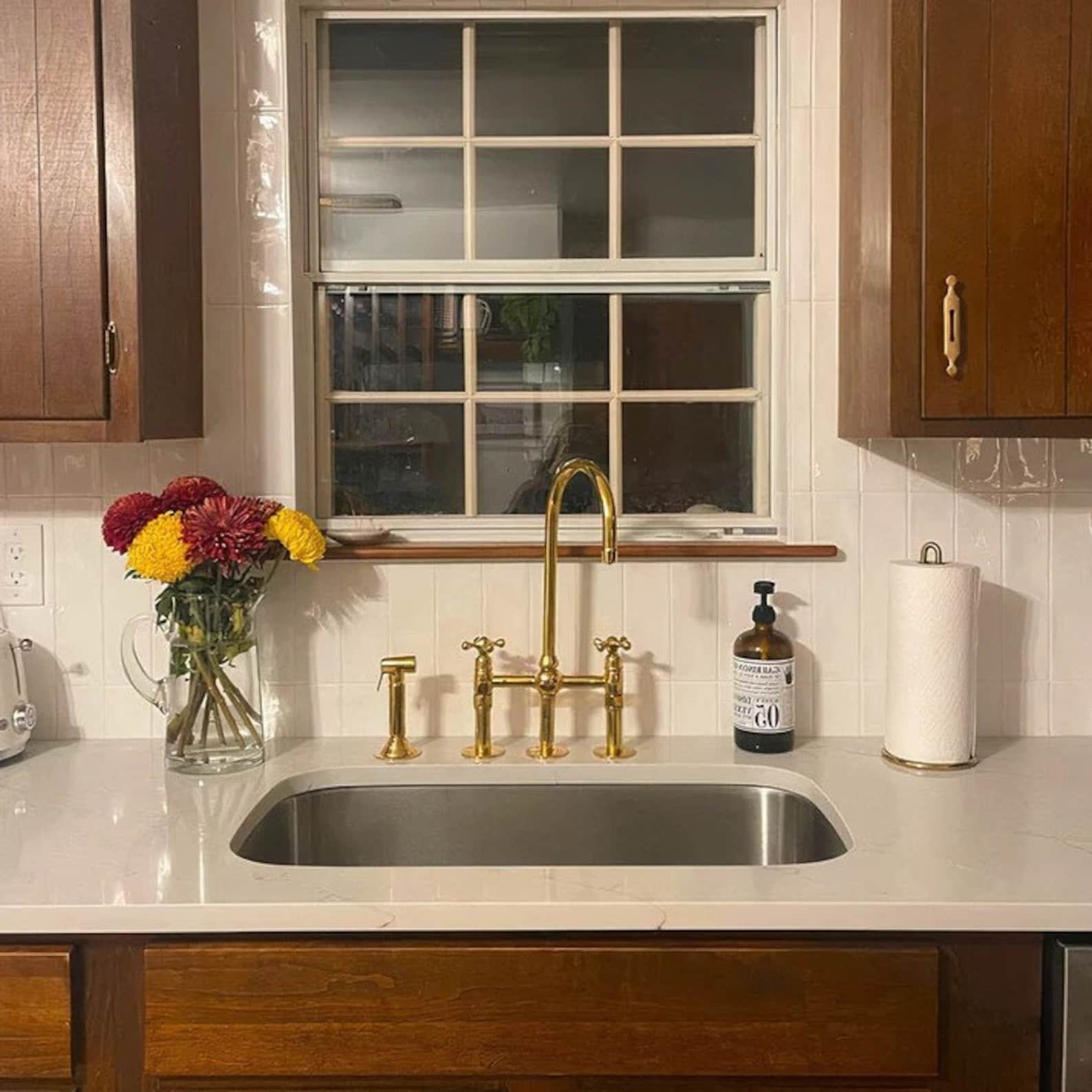 unlacquered brass kitchen faucet with sprayer