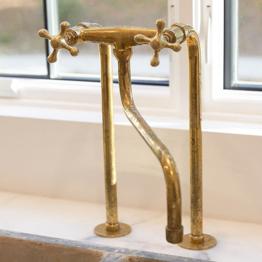 unlacquered brass faucet with tall legs