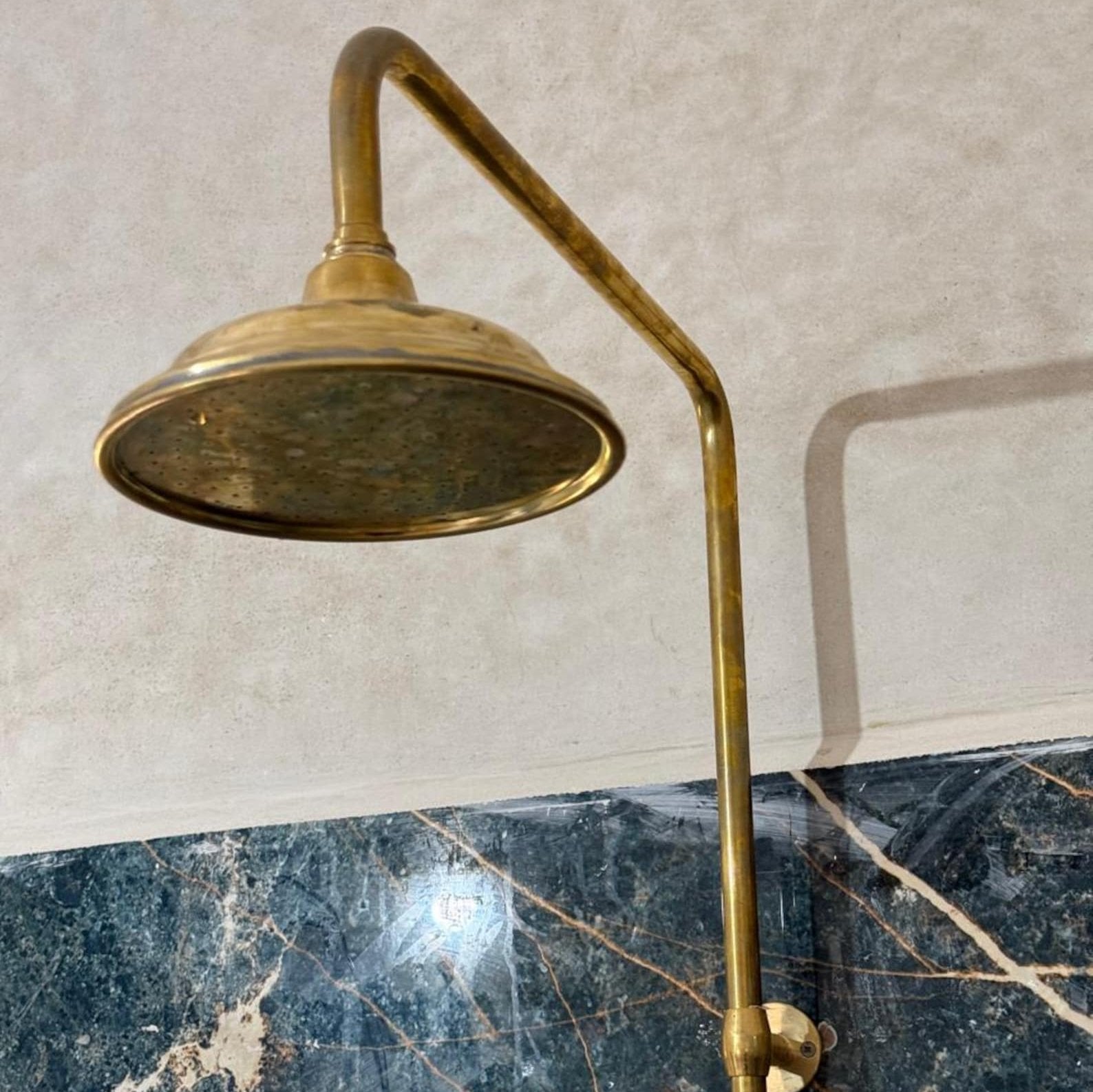 unlacquered brass shower head