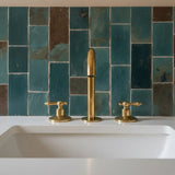 unlacquered brass deck mounted faucet with lever handles