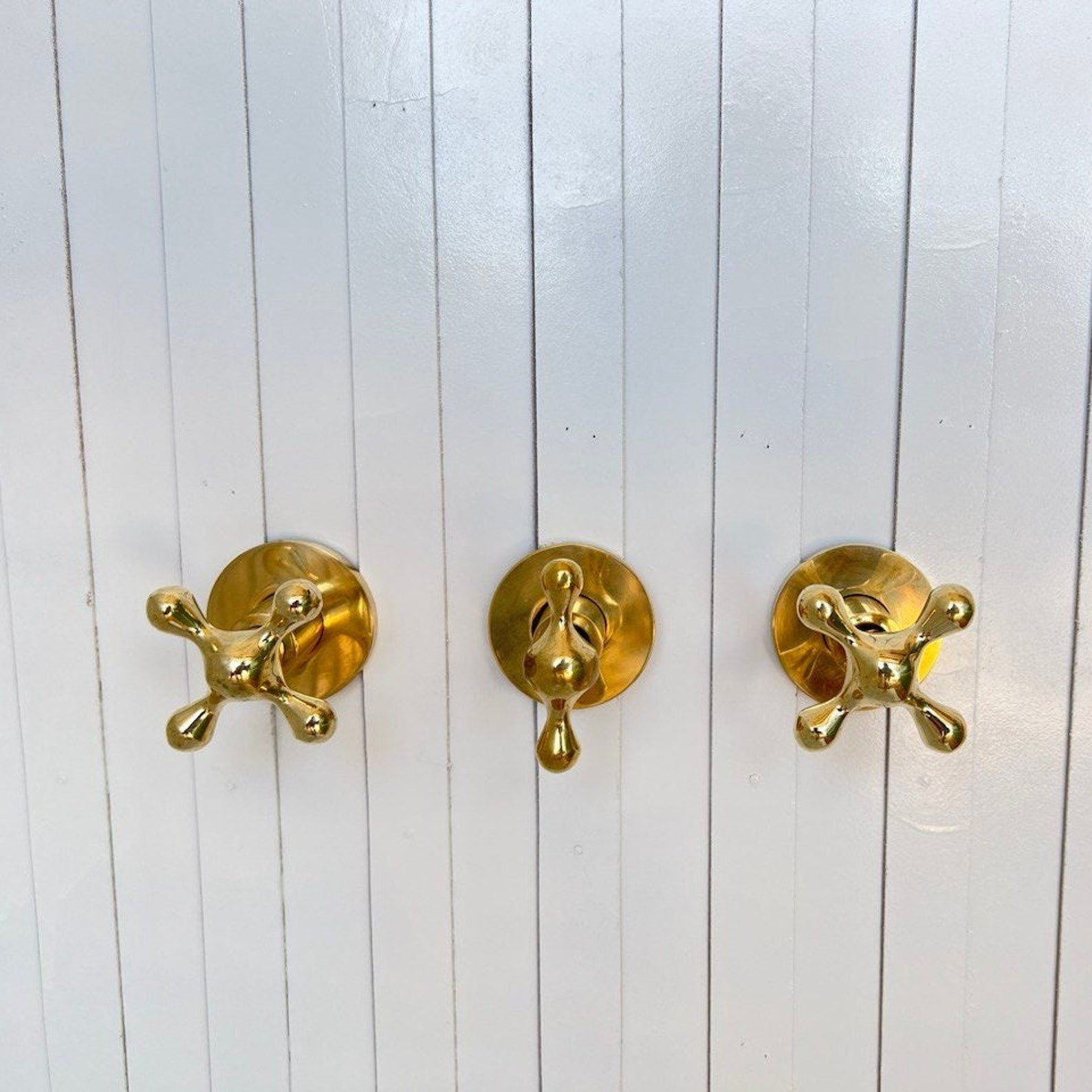 unlacquered brass wall mounted shower